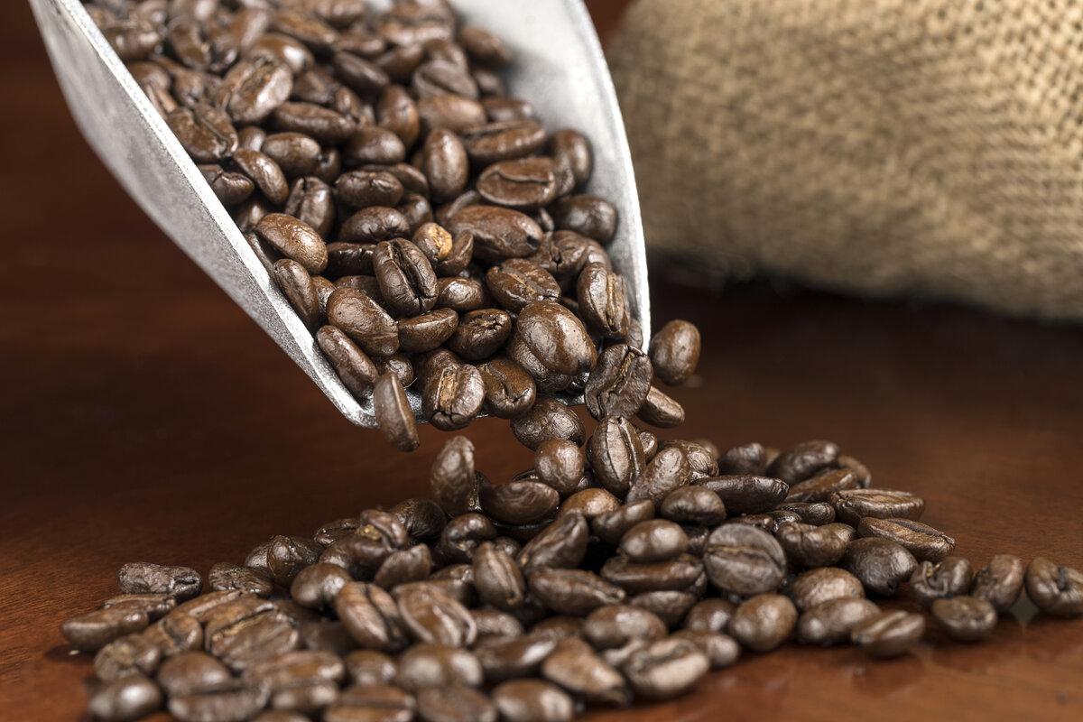 Coffee beans flowing from a scoop