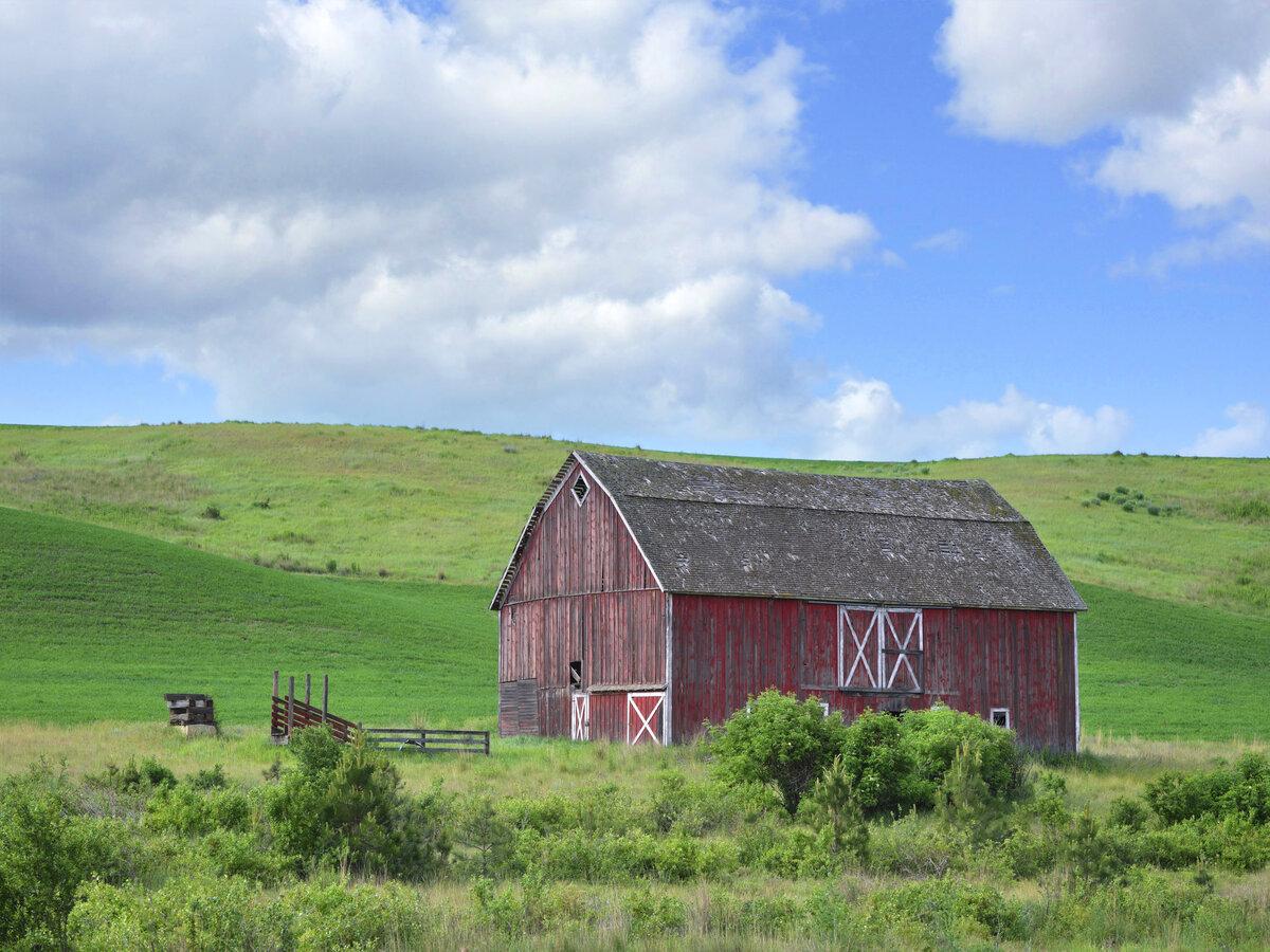 Rustic red barn under a partly cloudy sky
